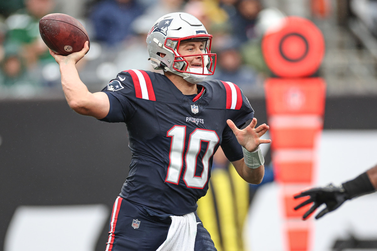 Mac Jones brings his arm back to throw the football